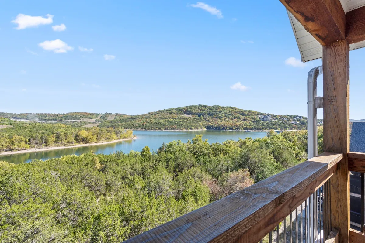 This tranquil view captures the lake bordered by lush greenery and distant hills, bathed in soft sunset light. The shoreline and open sky suggest opportunities for leisurely walks and outdoor adventures with pets.